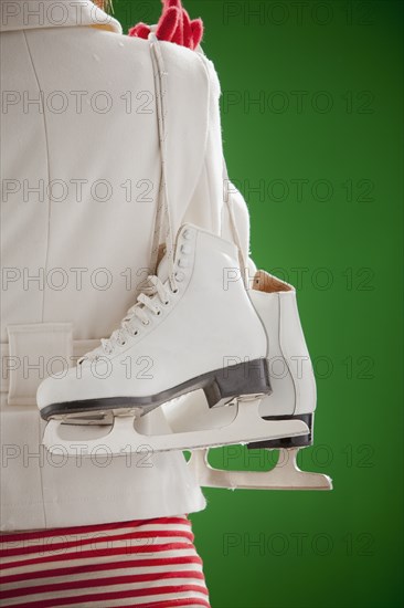 Mixed race woman carrying ice skates