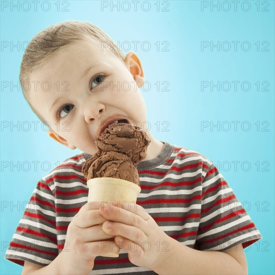 Caucasian boy eating ice cream cone