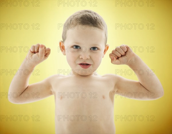 Caucasian boy flexing his biceps