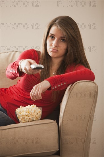 Bored Caucasian woman watching television