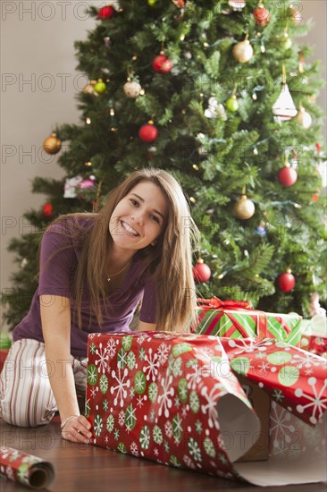 Caucasian woman wrapping Christmas gifts