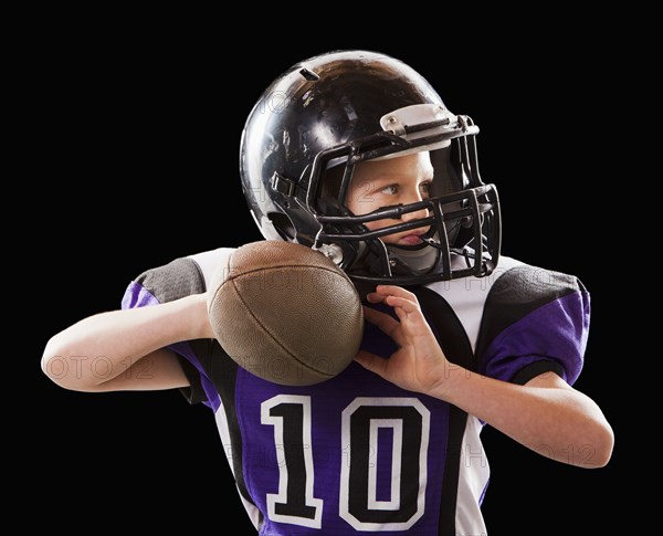 Caucasian football player throwing football