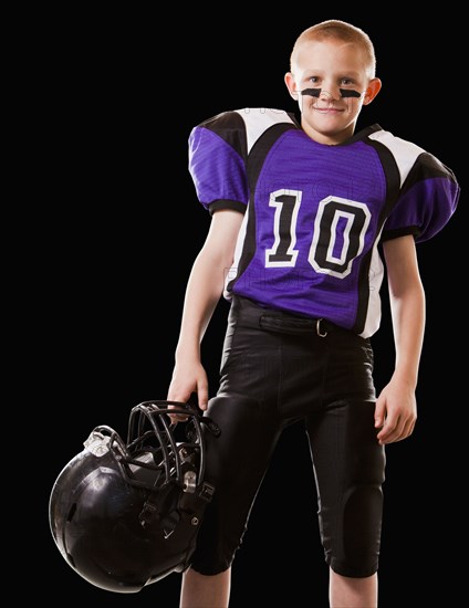 Smiling mixed race football player