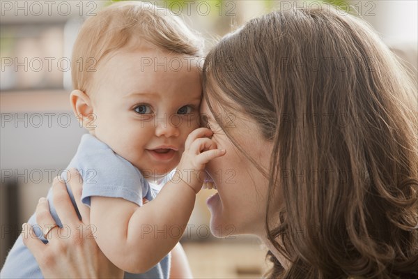 Caucasian mother hugging baby boy