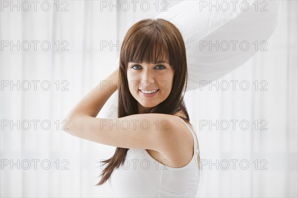 Caucasian woman about to throw pillow