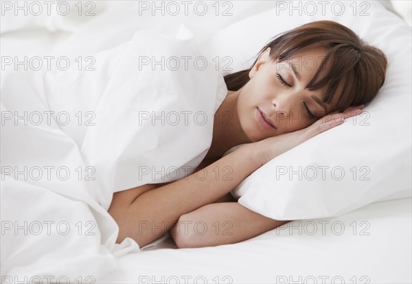 Caucasian woman sleeping in bed