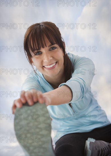 Caucasian woman stretching before exercise