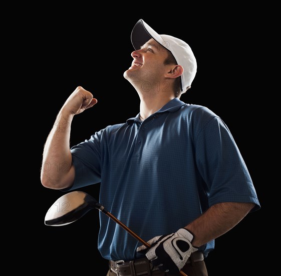 Cheering golfer holding golf club