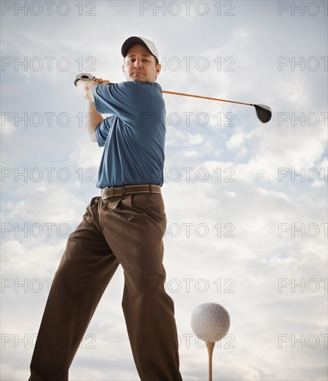 Caucasian golfer about to swing golf club