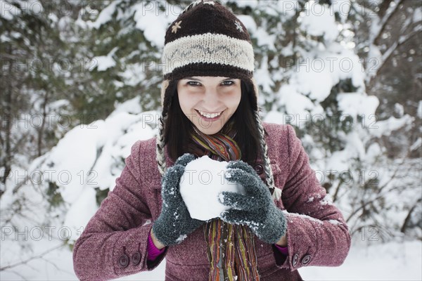 Caucasian woman making snowball