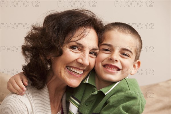 Caucasian grandmother hugging grandson