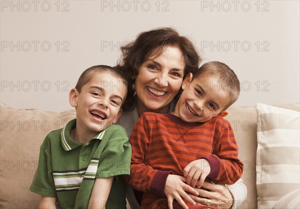 Caucasian grandmother sitting with grandsons