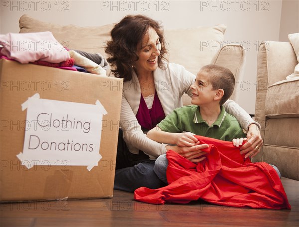 Caucasian grandmother and granddaughter donating clothing