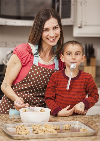 Caucasian mother and son baking cookies
