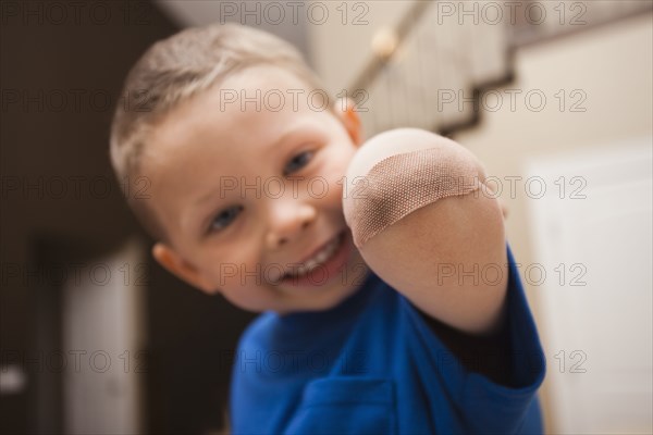 Caucasian boy with bandage on elbow