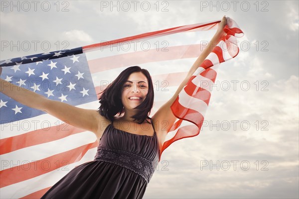 Caucasian woman holding American flag