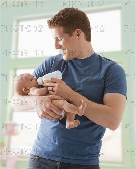 Caucasian father feeding baby girl