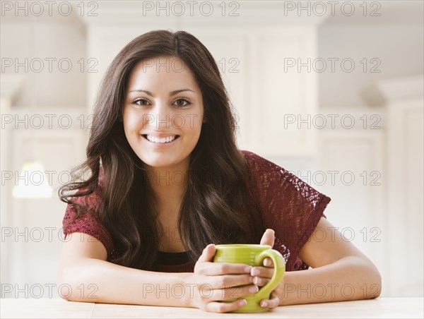 Mixed race woman drinking coffee