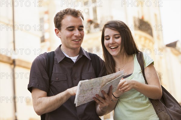 Caucasian couple looking at map