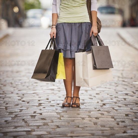 Caucasian woman holding shopping bags