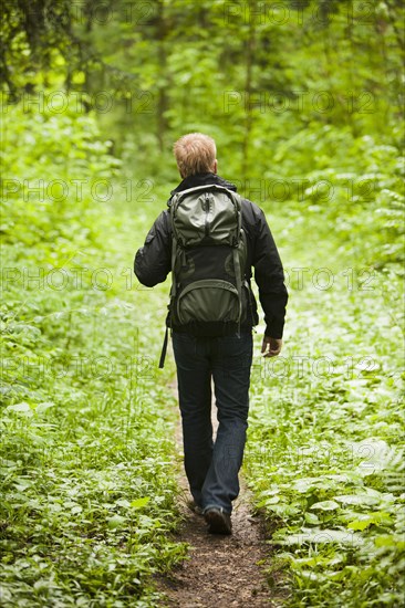 Caucasian man hiking in woods