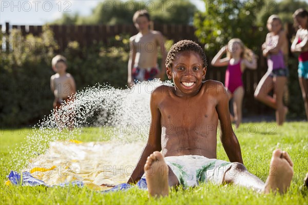 Black boy playing in water