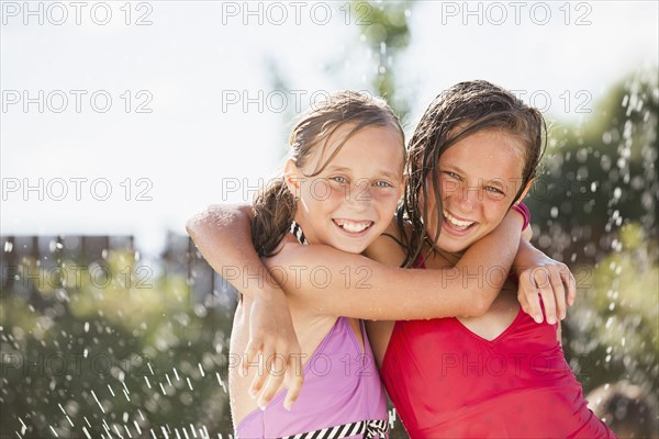 Caucasian girls playing in water