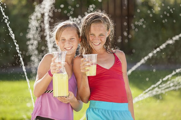 Caucasian girls drinking lemonade