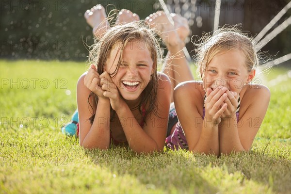 Caucasian girls laying in the grass