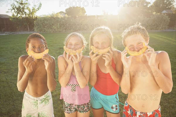 Children eating cantaloupe