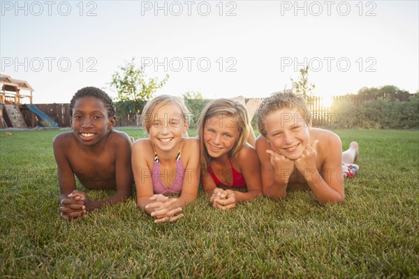 Children laying in the grass together