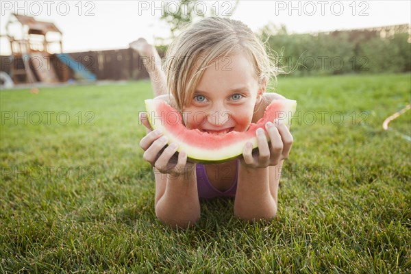 Caucasian girl eating watermelon