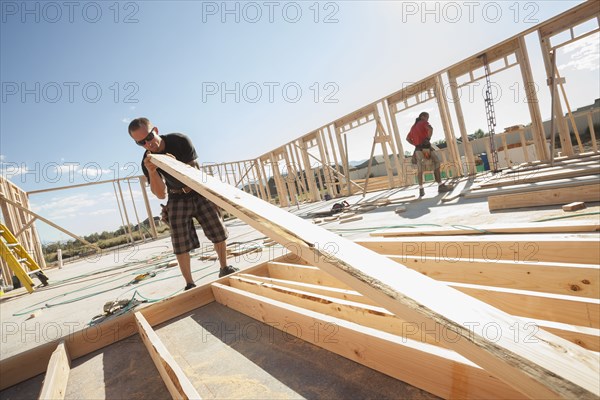 Caucasian man working on frame on construction site