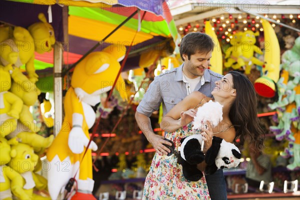 Caucasian couple enjoying carnival