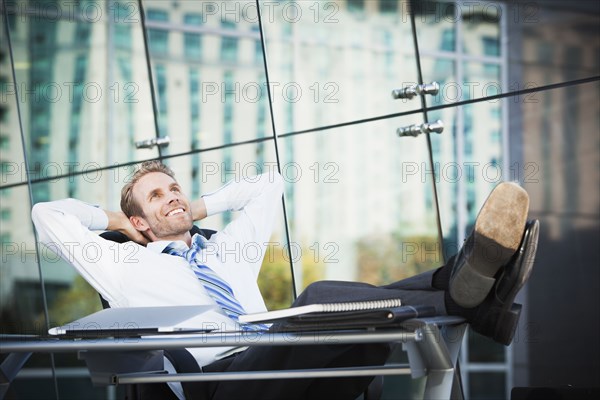 Caucasian businessman relaxing at desk