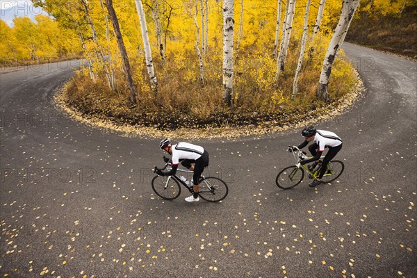 Caucasian cyclists on rural road