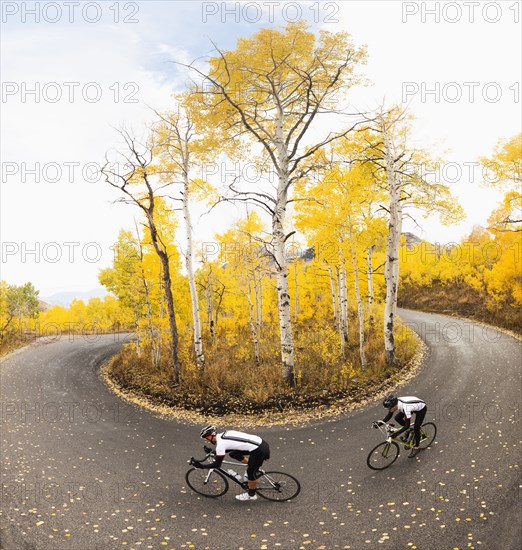 Caucasian cyclists on rural road