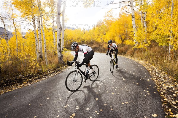 Caucasian cyclists on rural road