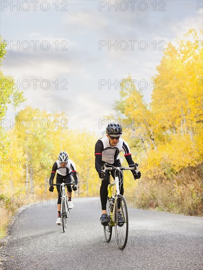 Caucasian cyclists on rural road