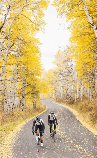 Caucasian cyclists on rural road