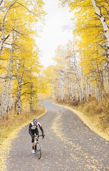 Caucasian cyclist on rural road