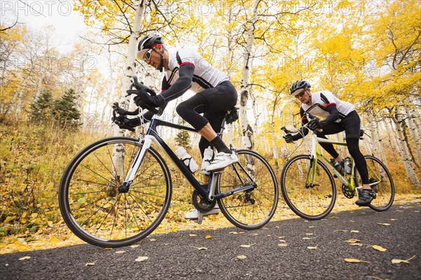 Caucasian cyclists on rural road