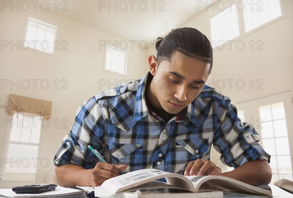 Hispanic man studying at desk