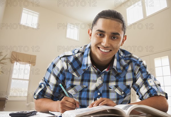 Smiling Hispanic man studying