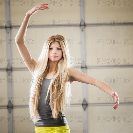 Caucasian dancer practicing in studio