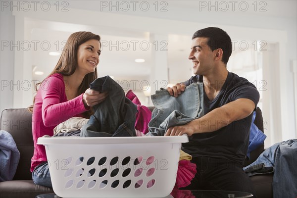 Couple sorting laundry together
