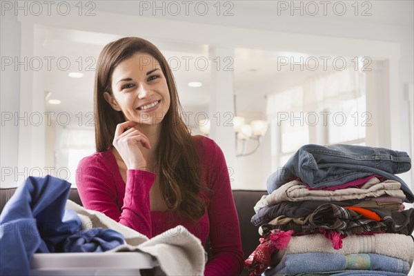 Caucasian woman folding laundry