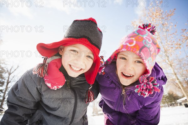 Caucasian children smiling in snow