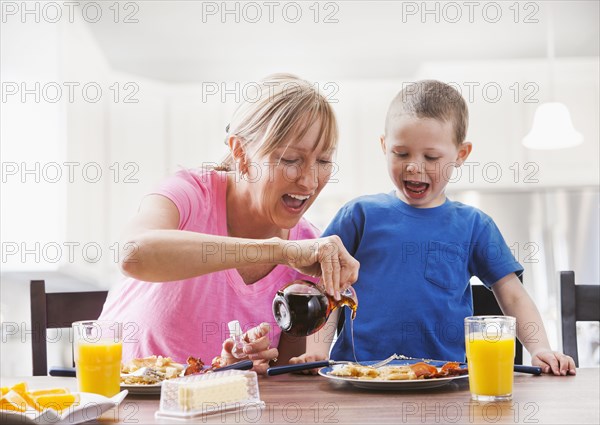 Caucasian mother and son having breakfast