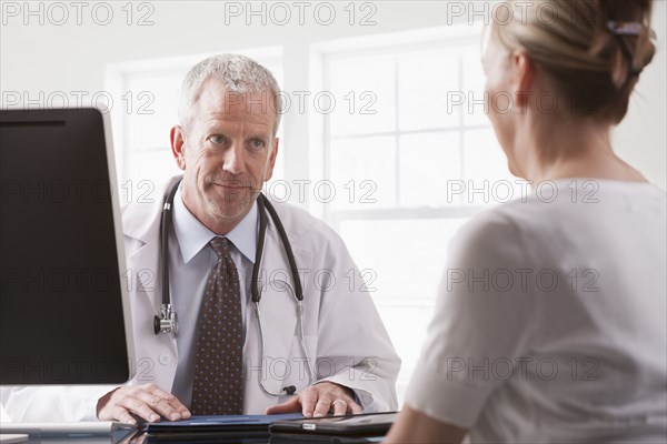 Caucasian doctor talking with patient
